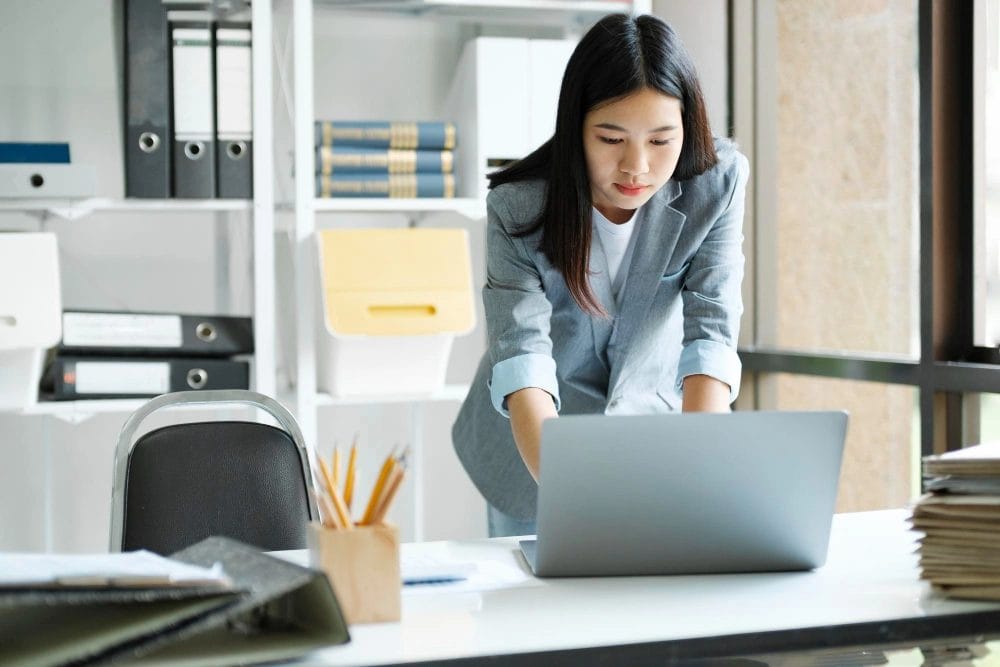 young-asian-businesswoman-working-office-using-laptop