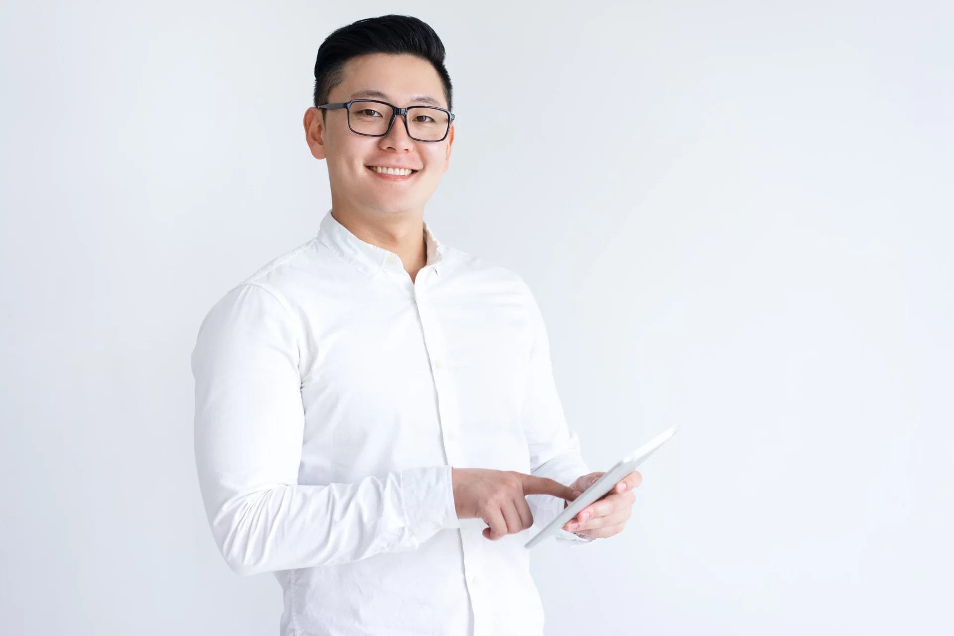 smiling-asian-man-using-tablet-computer smiling-asian-man-using-tablet-computer